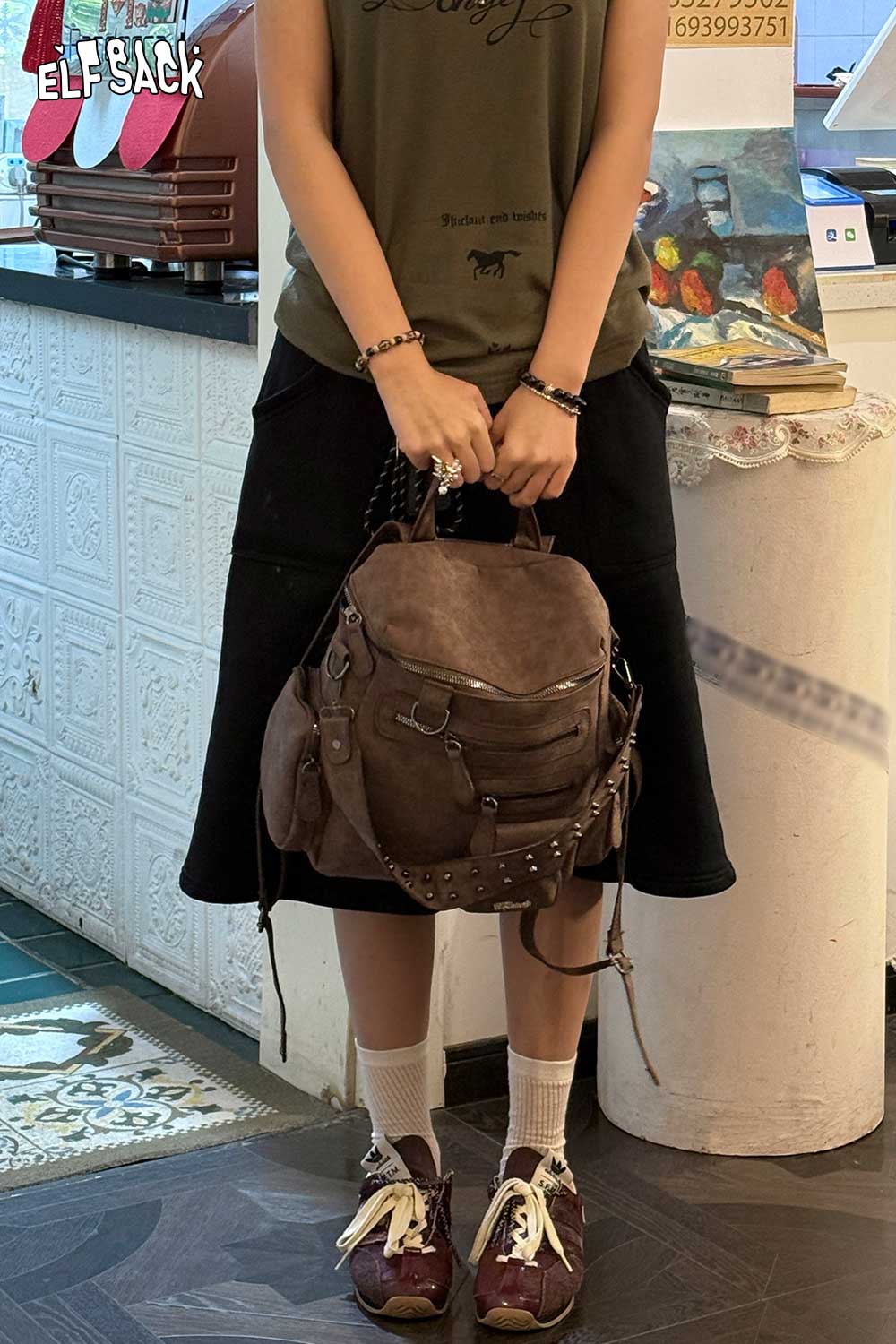 ELFSACK suede multi-compartment rucksack styled with casual outfit for everyday use