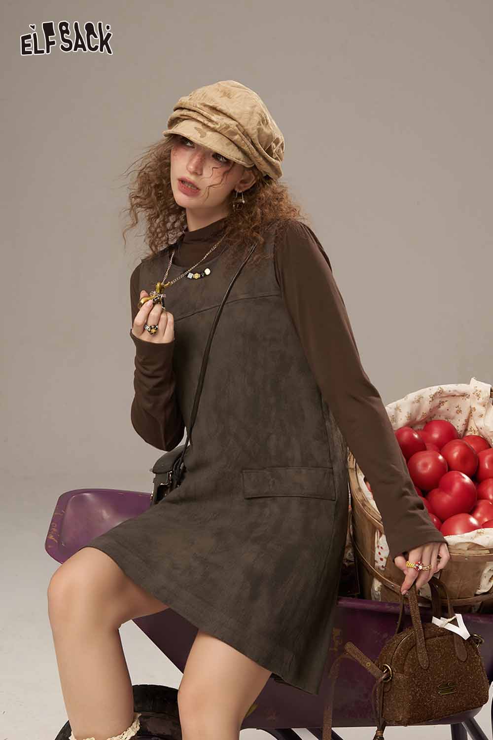 ELFSACK suede paneled turtleneck dress in brown, styled with a vintage cap and accessories