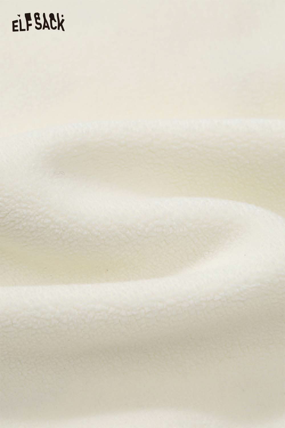Soft fabric of ELFSACK teddy bear applique hoodie in cream color, perfect for cozy layering