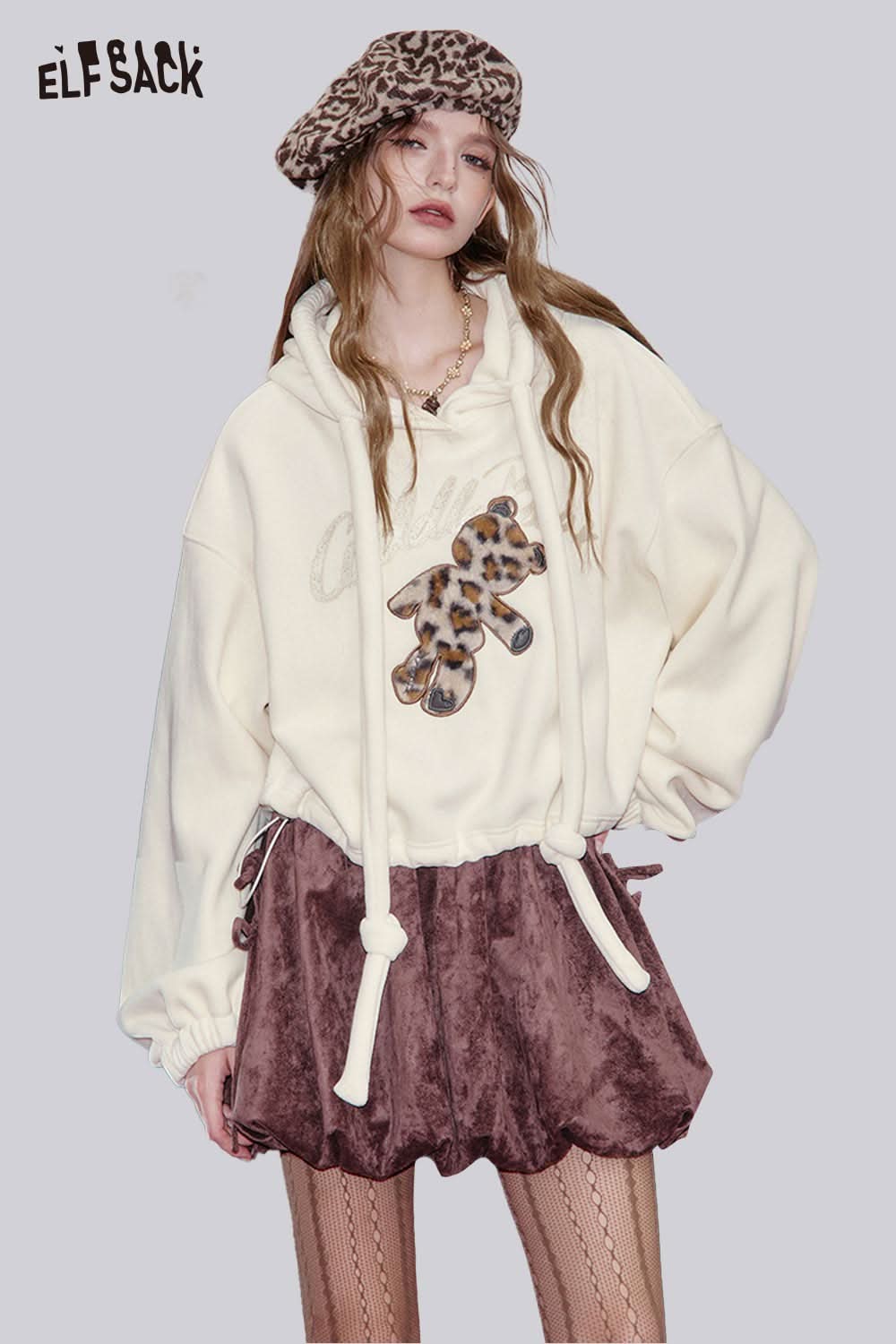 ELFSACK teddy bear applique hoodie in cream with a playful leopard print bear design