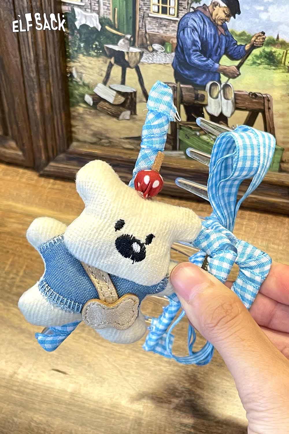ELFSACK teddy bear hair clip featuring a cute bear design with denim overalls and blue ribbons