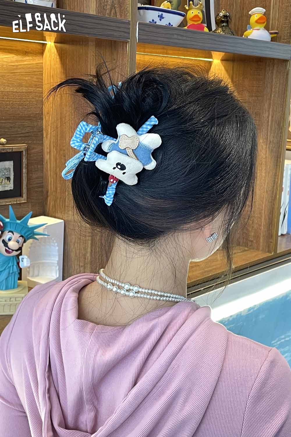 ELFSACK teddy bear hair clip styled in a messy bun with playful ribbons for a fun look