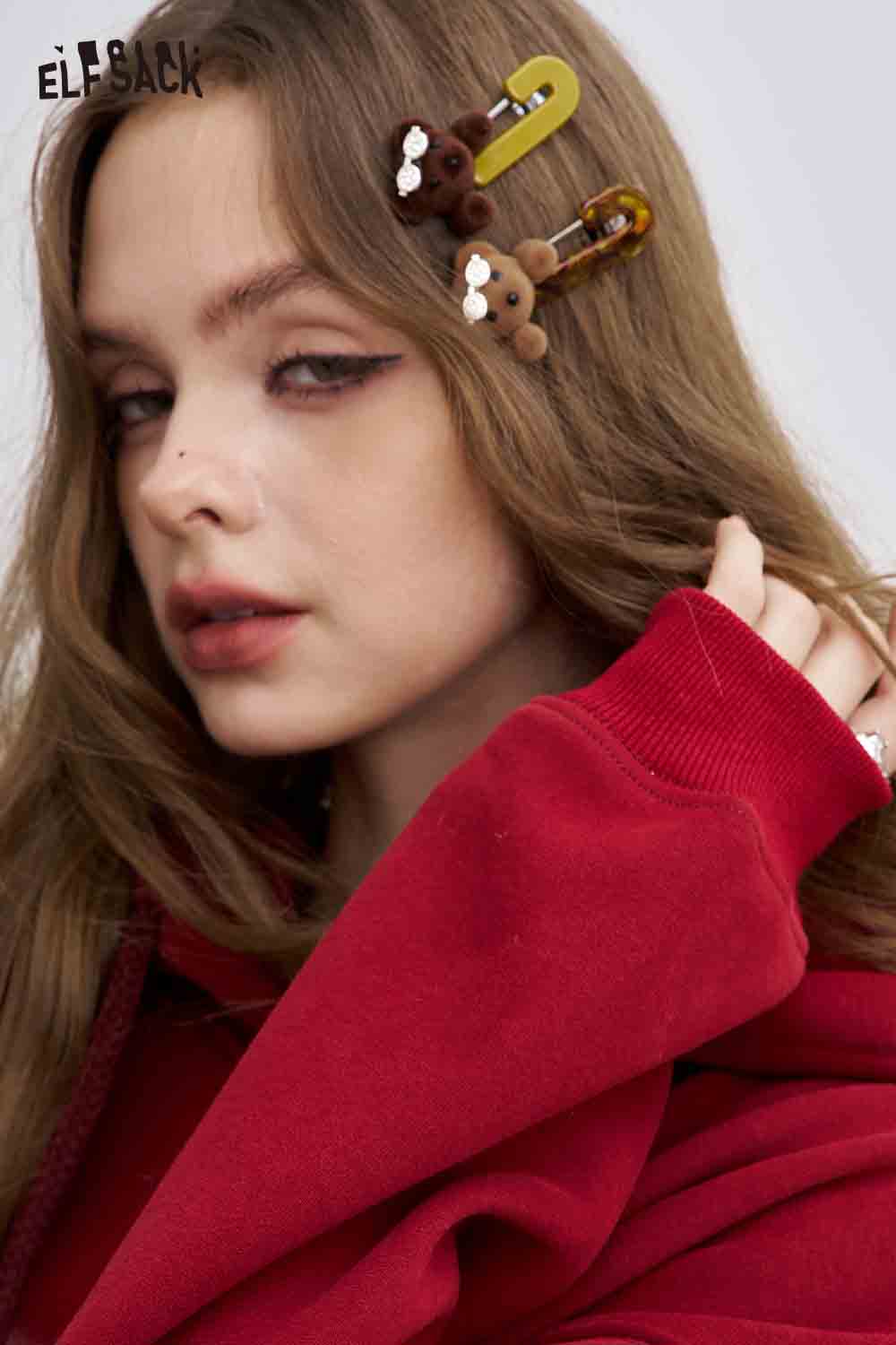 ELFSACK teddy bear hair clips in brown and yellow on a model's hair for a cute and playful look