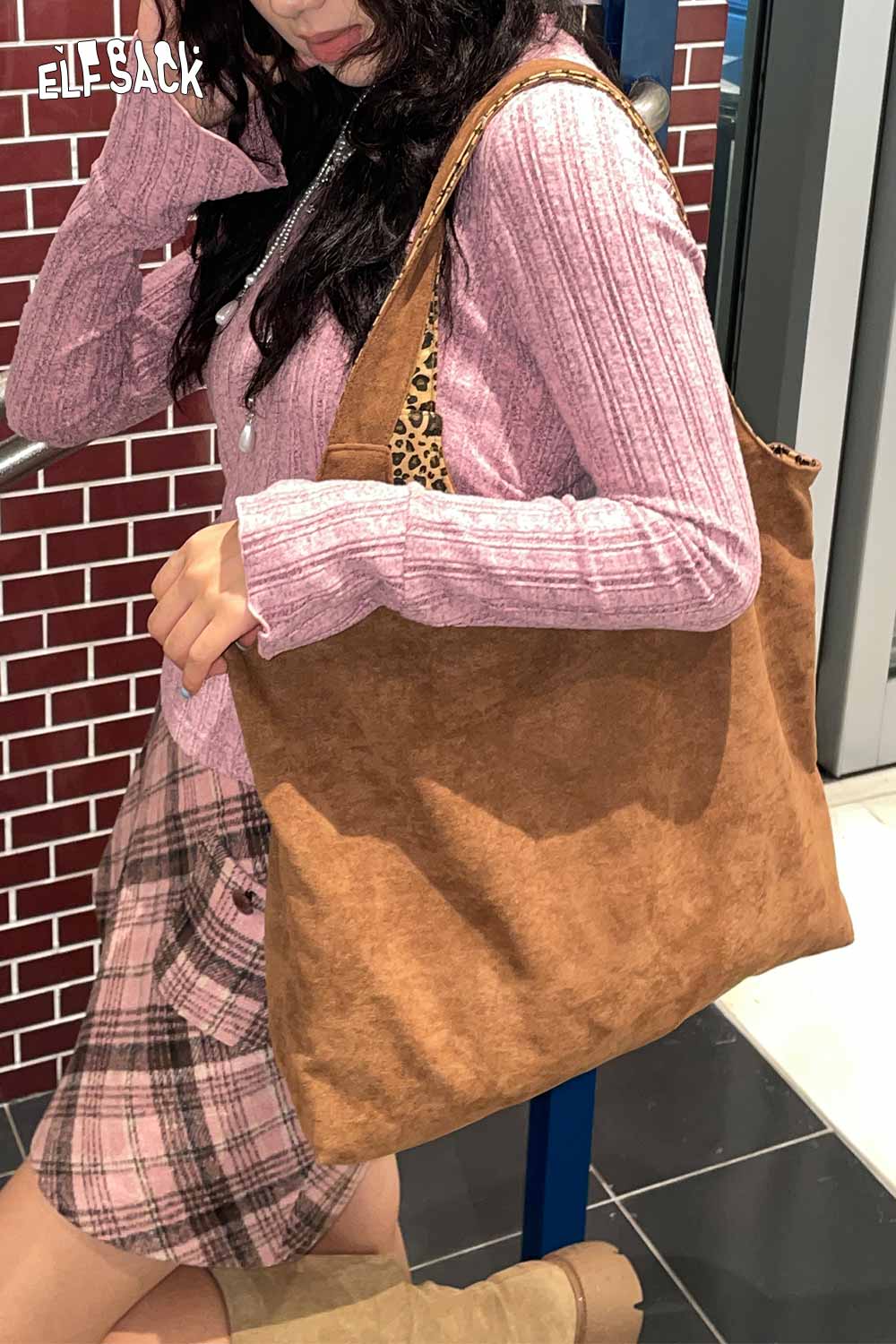Textured oversized hobo bag in brown held by model with casual outfit, perfect for everyday use
