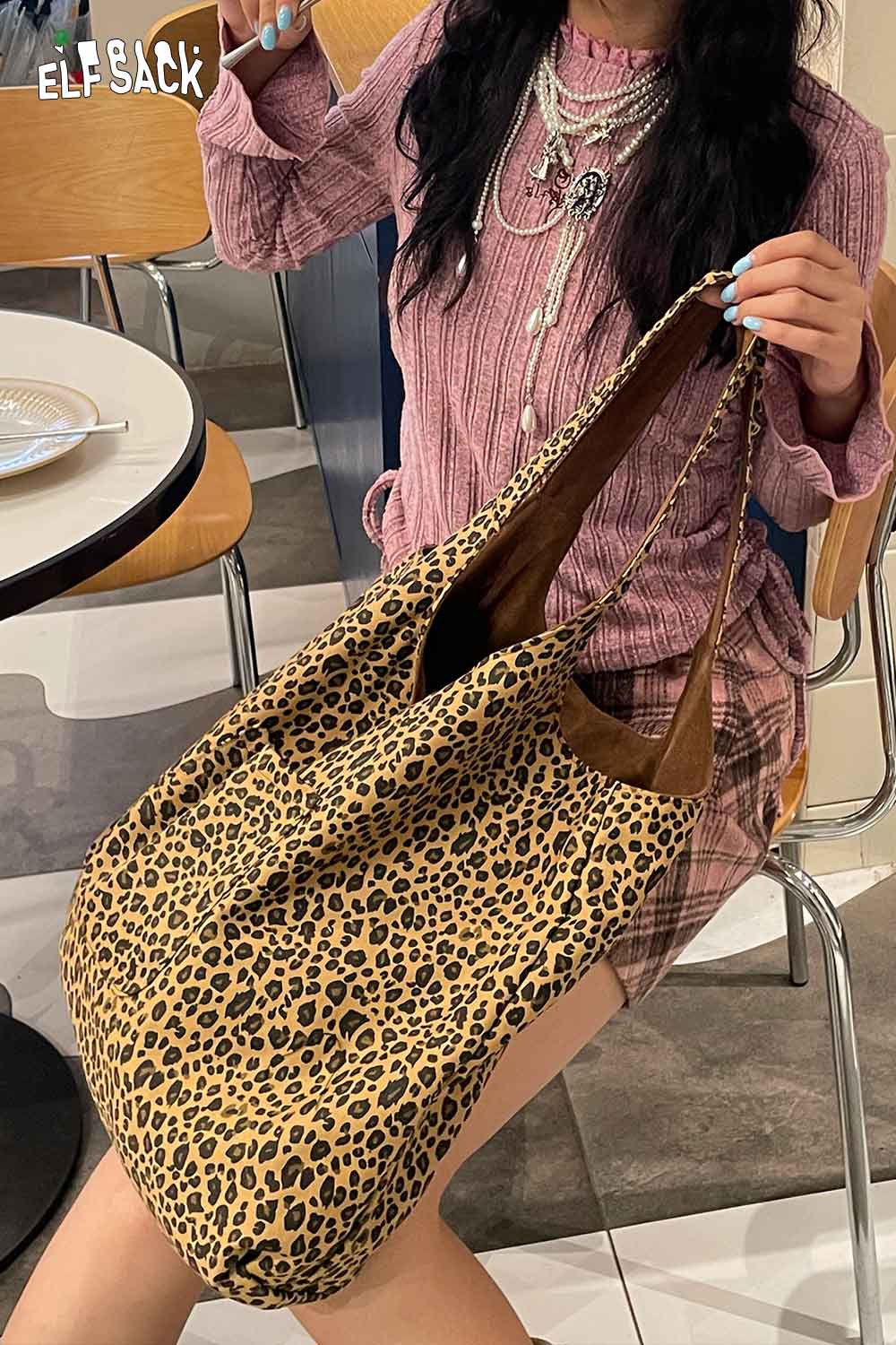 ELFSACK textured oversized hobo bag in leopard print paired with casual outfit for trendy look