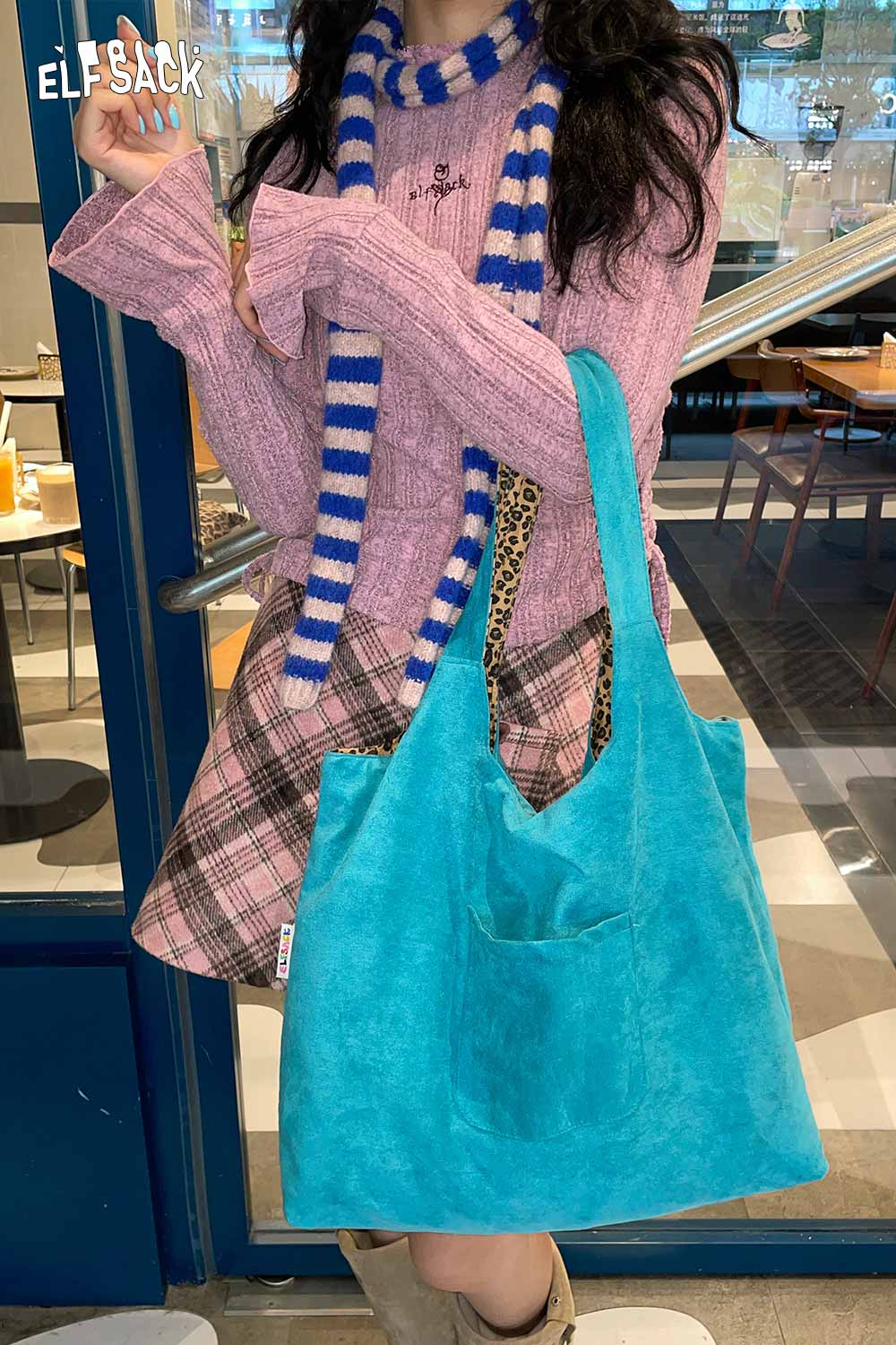 ELFSACK textured oversized hobo bag in turquoise with a front pocket, modelled in casual outfit