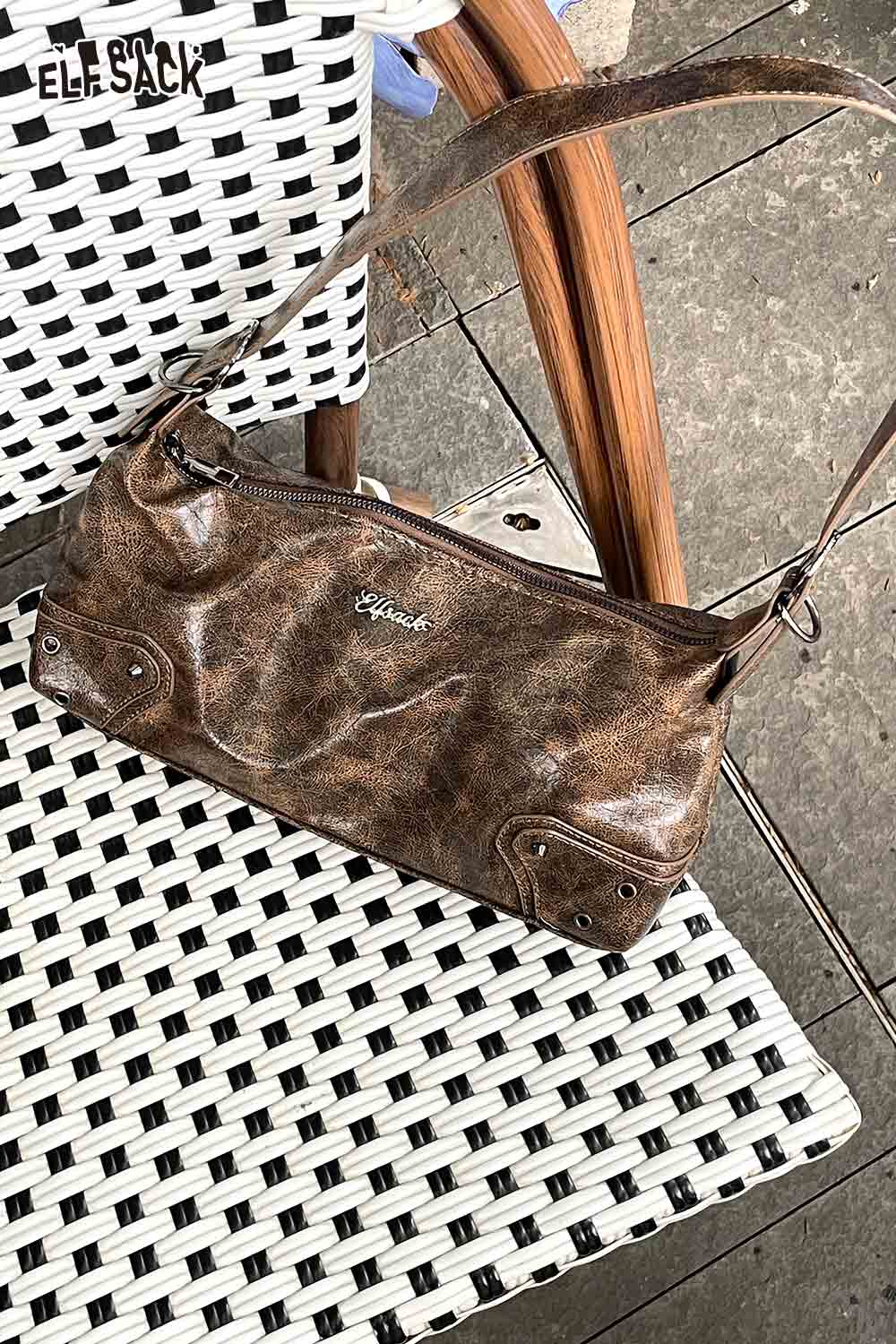 ELFSACK vegan leather 90s shoulder bag in brown placed on a modern chair