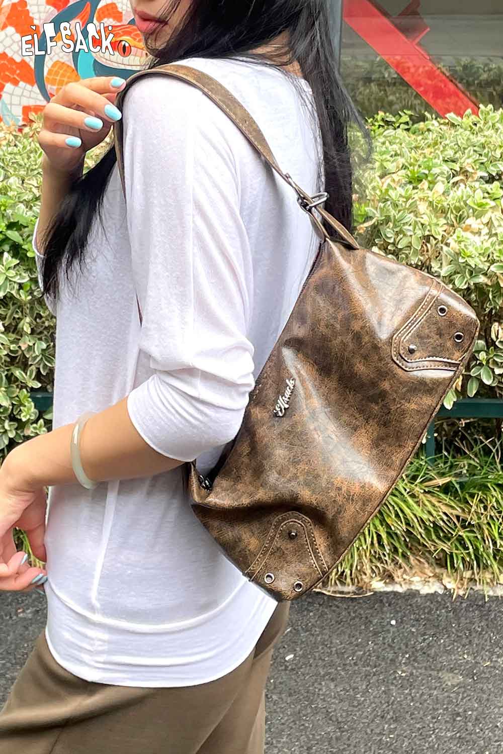 ELFSACK vegan leather 90s shoulder bag in a brown finish, styled on a model outdoors