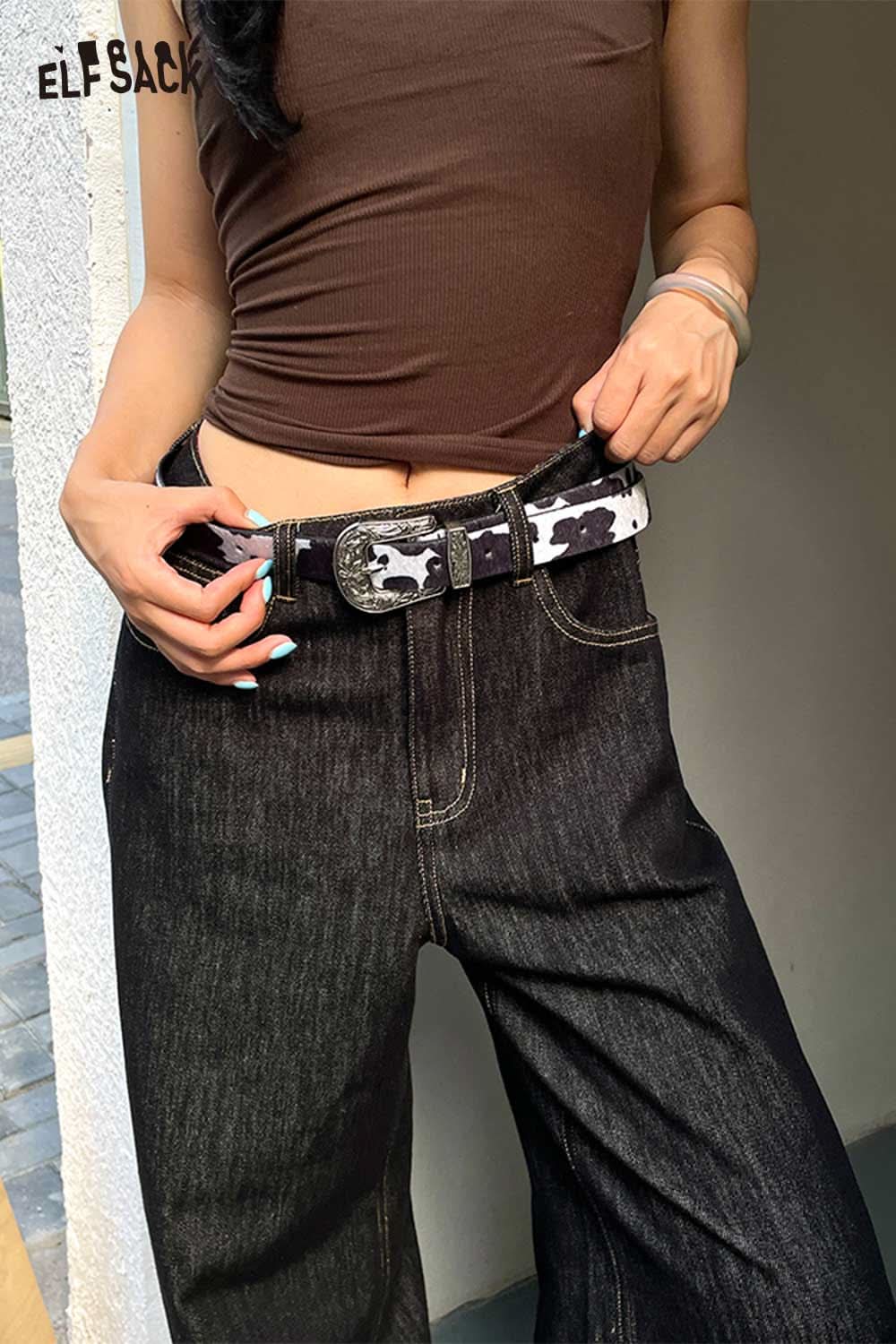 ELFSACK vegan leather cowhide pattern belt styled with dark denim jeans for a trendy look