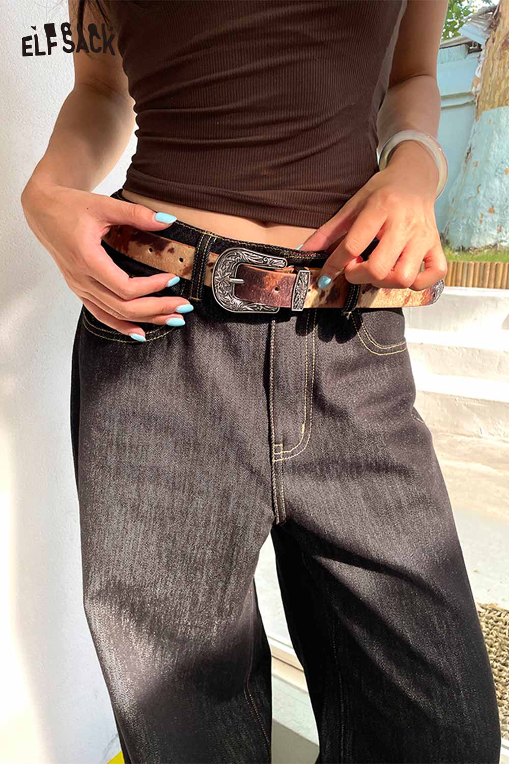 ELFSACK vegan leather cowhide pattern belt styled with black jeans for a trendy casual look
