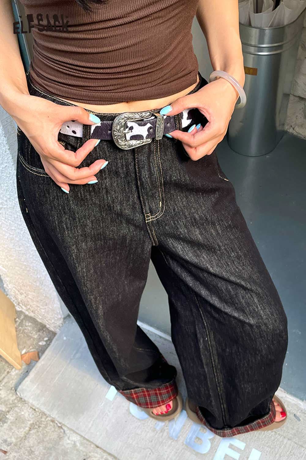 ELFSACK vegan leather cowhide pattern belt styled with high-waisted black jeans for a trendy look