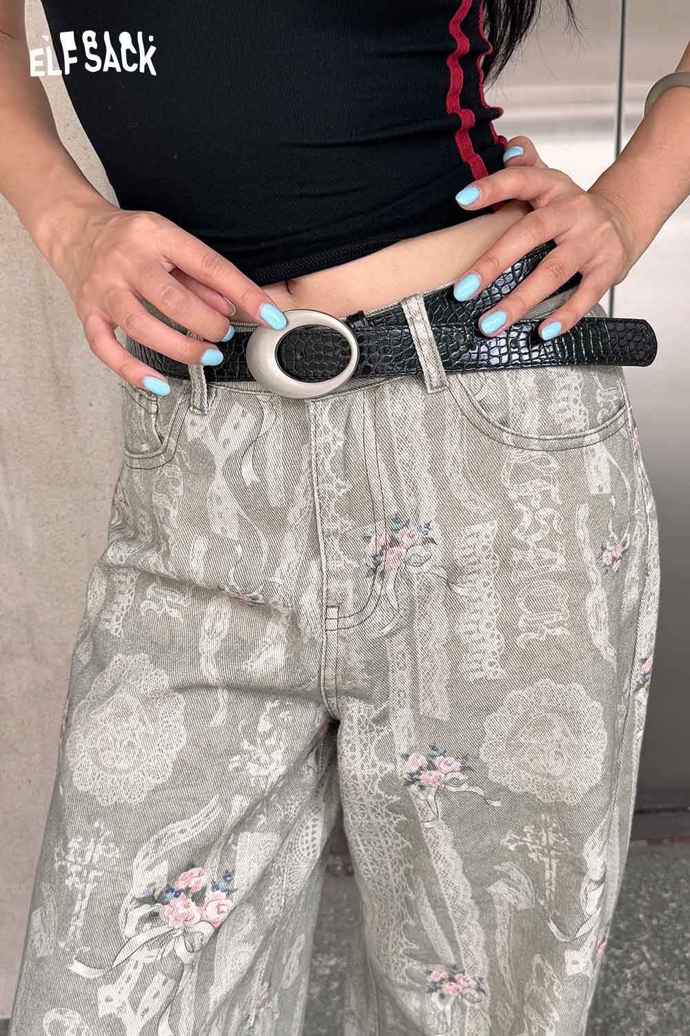 ELFSACK vegan leather croc-embossed belt styled with floral printed pants for a trendy look