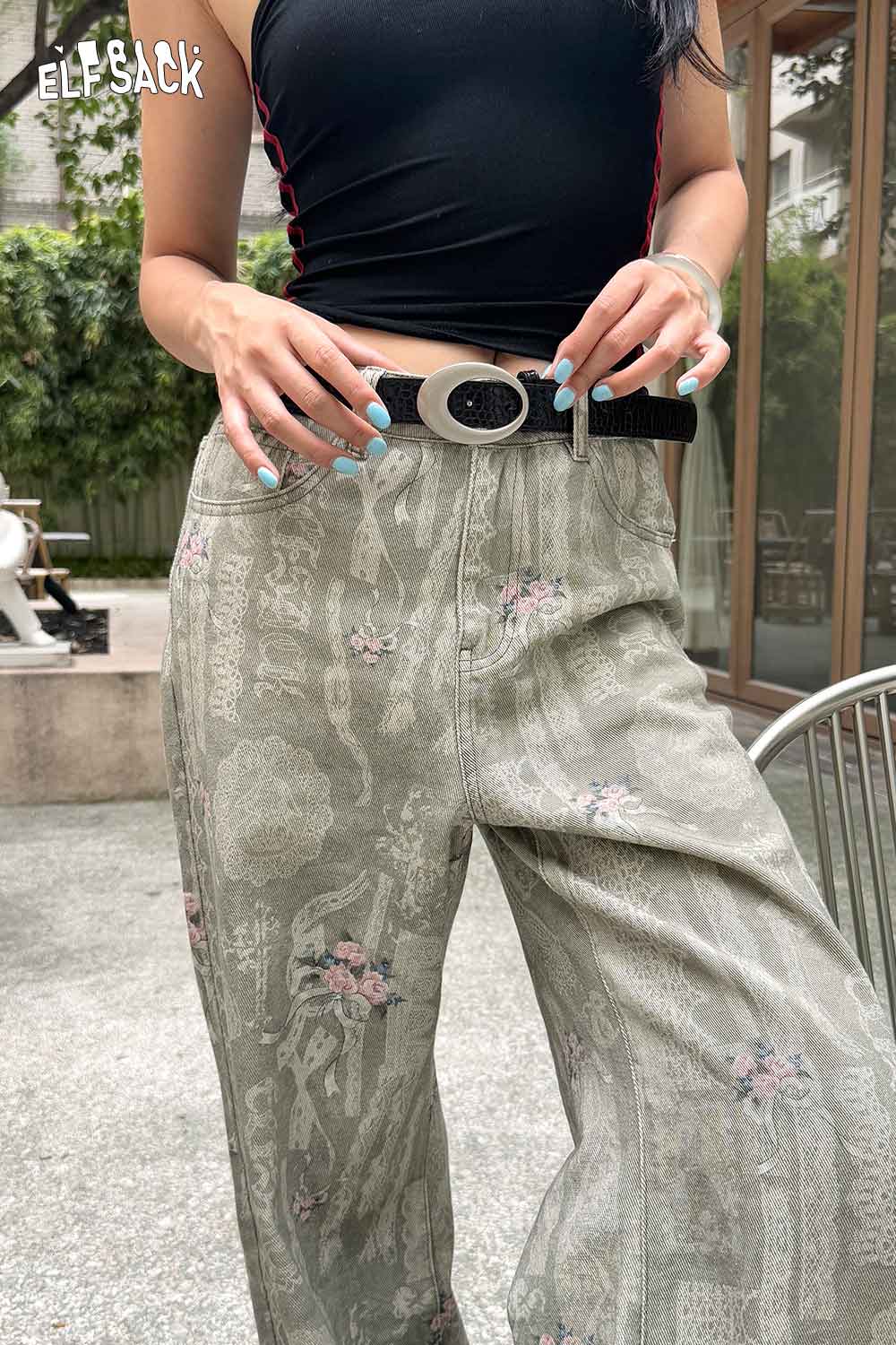 Stylish ELFSACK vegan leather croc-embossed belt paired with floral patterned high-waisted pants