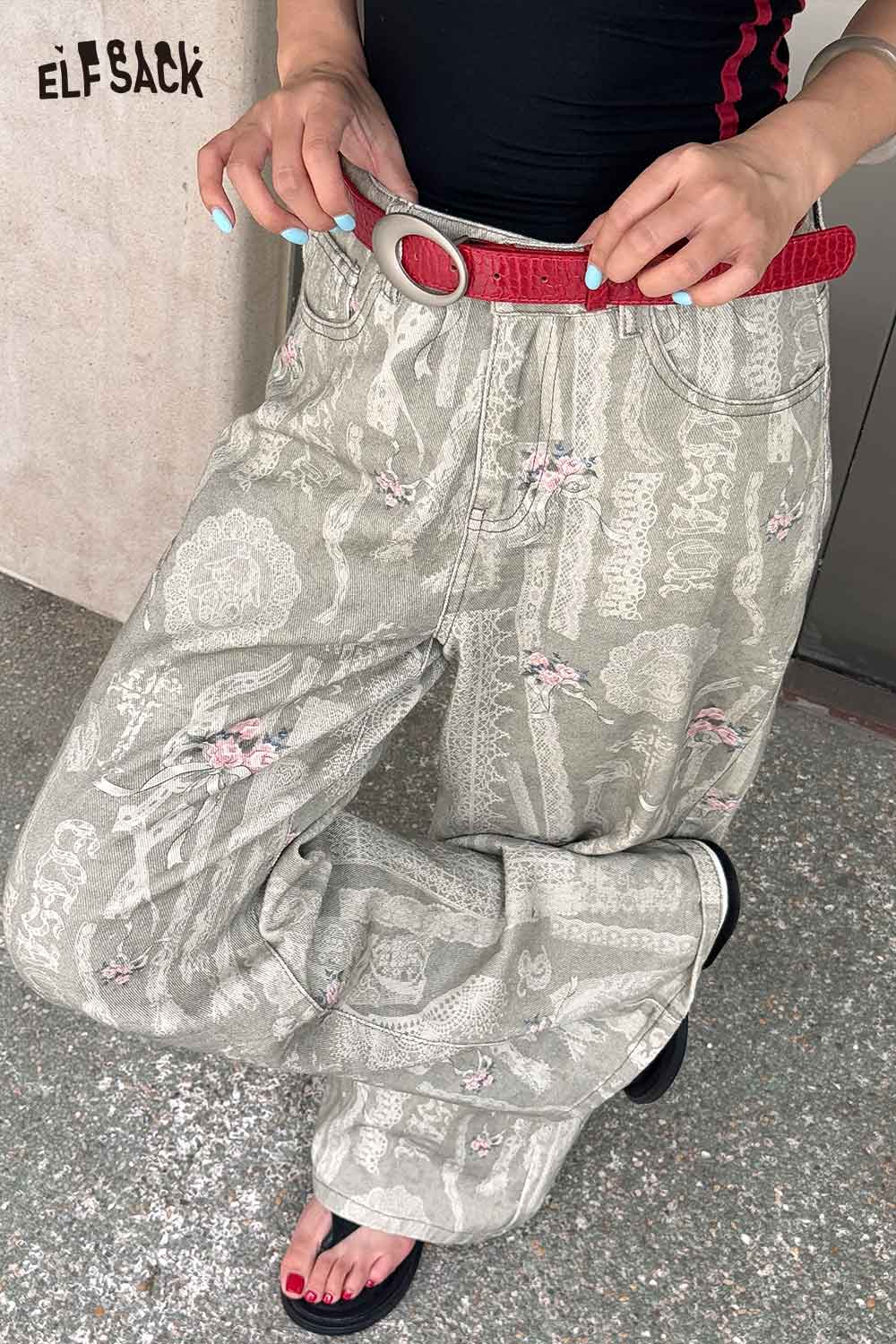 ELFSACK vegan leather croc-embossed belt in red paired with stylish patterned pants for a trendy look
