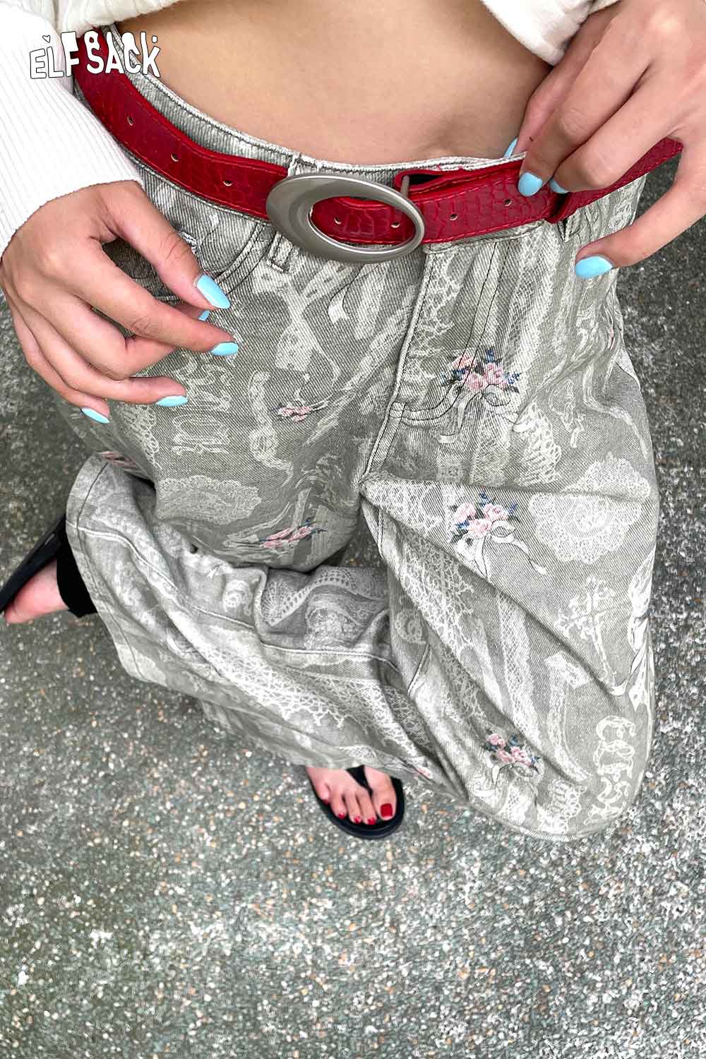 ELFSACK Vegan leather croc-embossed belt styled with patterned pants for a trendy look