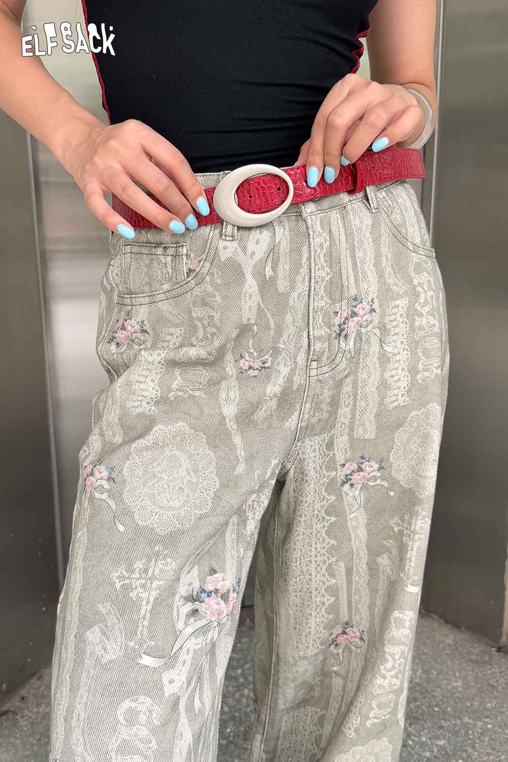 ELFSACK vegan leather croc-embossed belt in red, styled with high-waisted floral print pants