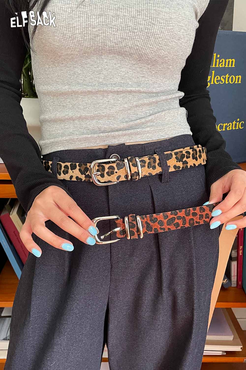 ELFSACK vegan suede animal print belt showcased on a model with stylish gray top and tailored pants