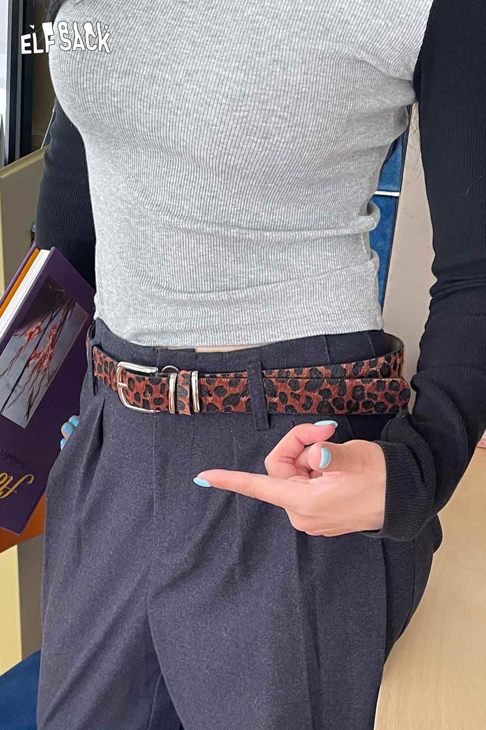 ELFSACK vegan suede animal print belt paired with gray shirt and stylish trousers for a trendy look
