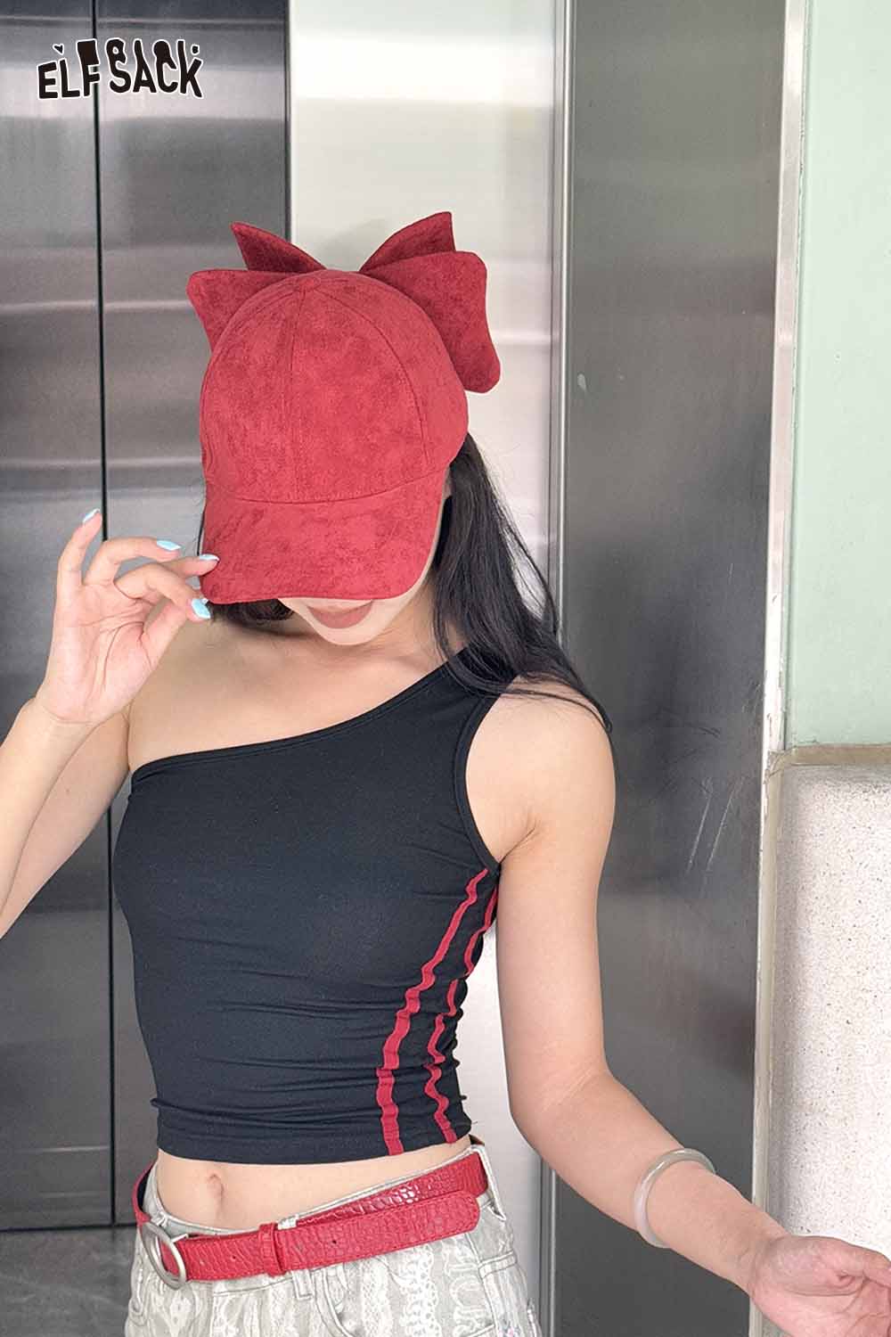 ELFSACK velour bow baseball cap in red paired with a stylish black top for a chic look
