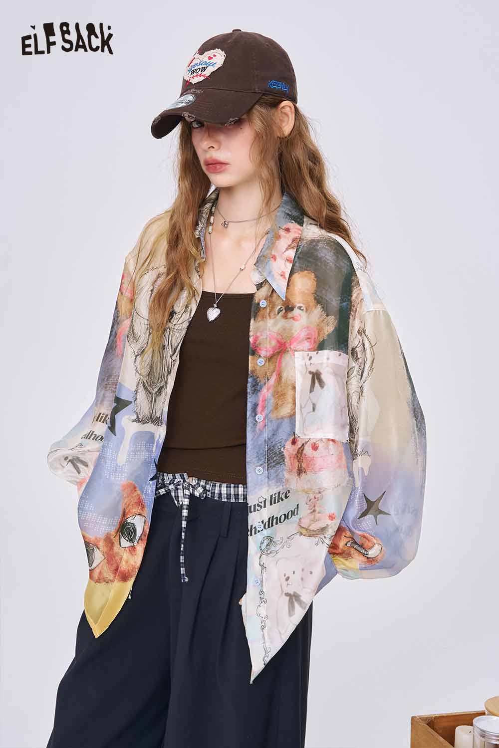 ELFSACK female model wearing an oversized all over print long sleeve shirt pastel collage print