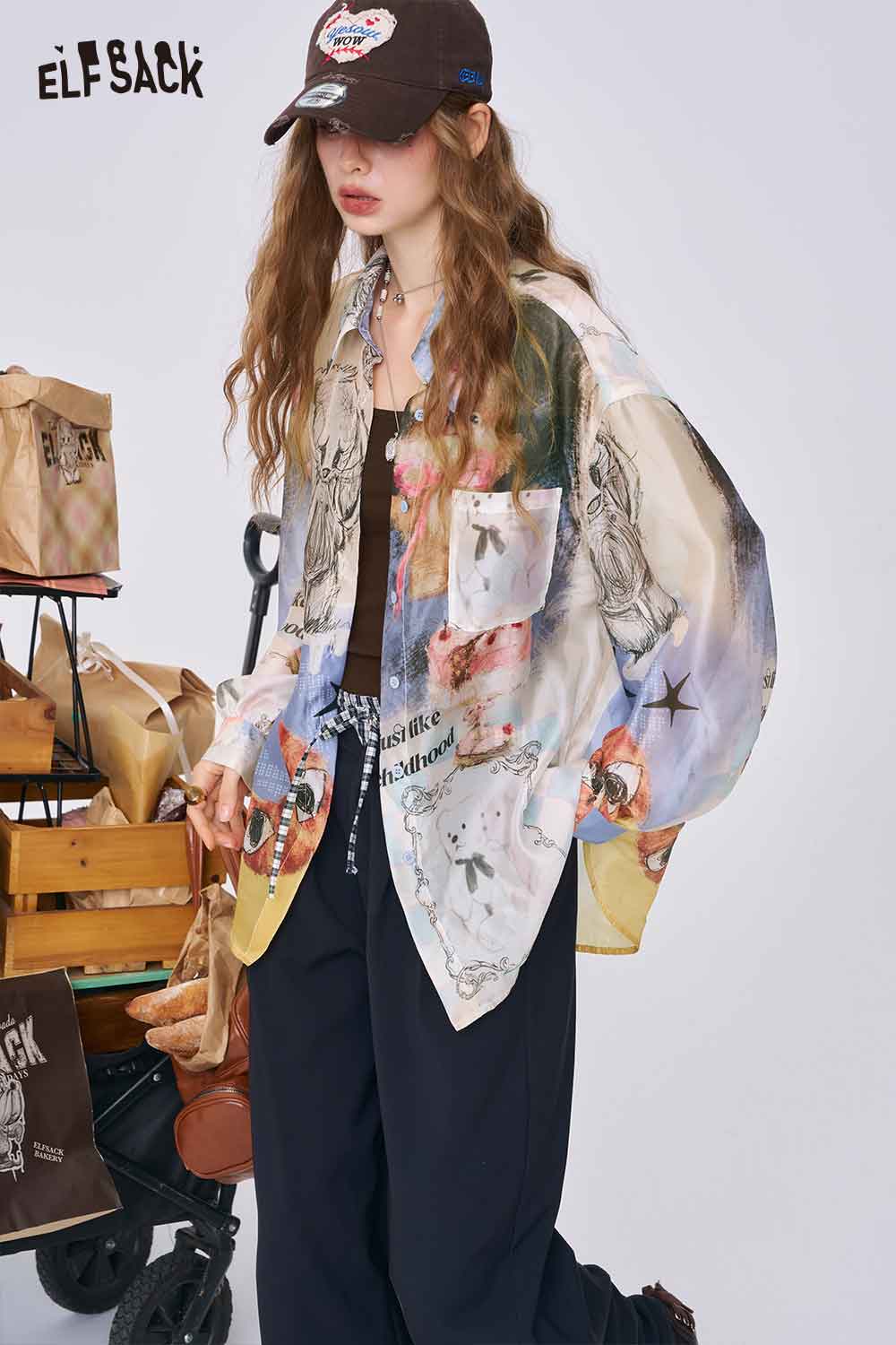 ELFSACK women model wearing all over print long sleeve shirt oversized colorful collage print with black tank and cap