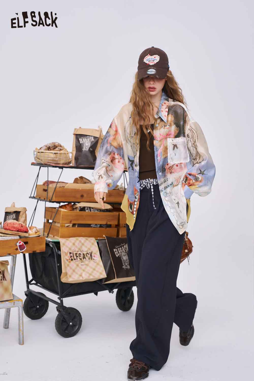 ELFSACK model wearing pastel collage all over print long sleeve shirt oversized with wide leg pants