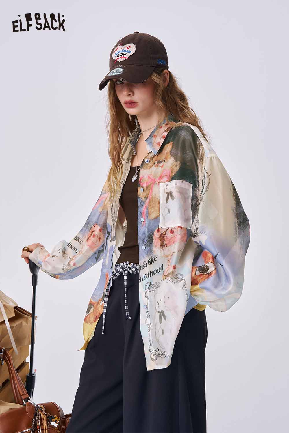 ELFSACK women model wearing multicolor sheer all over print long sleeve shirt with casual black cap and pants