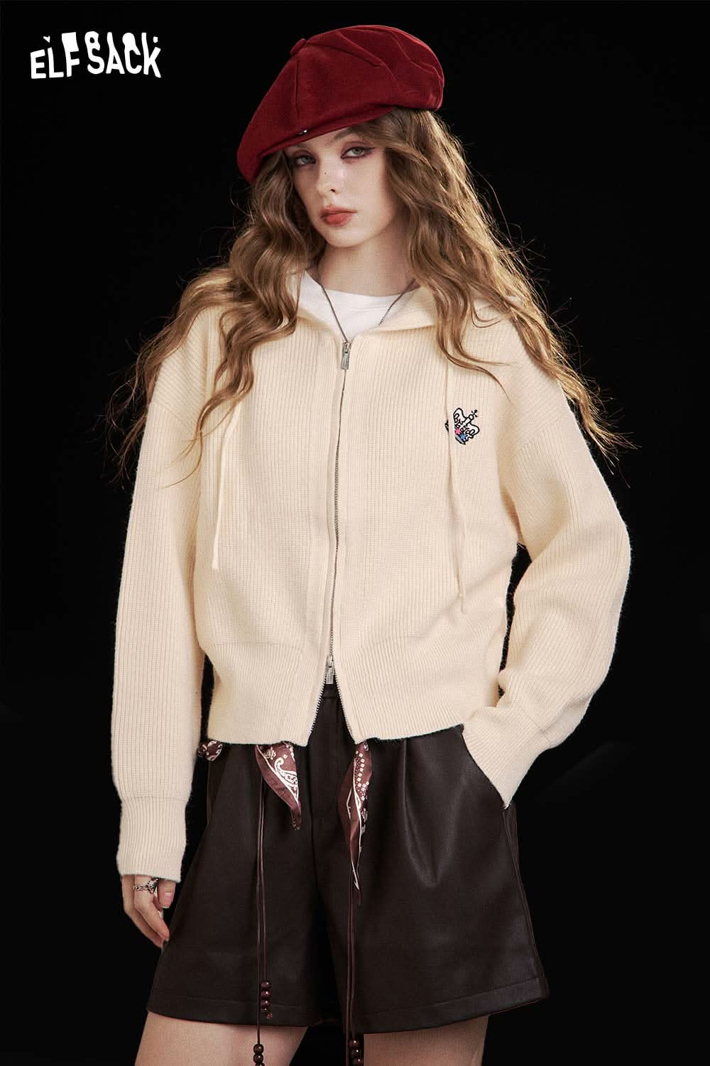 ELFSACK crown embroidered knit sweater in cream, featuring a zip-up design and ribbed texture