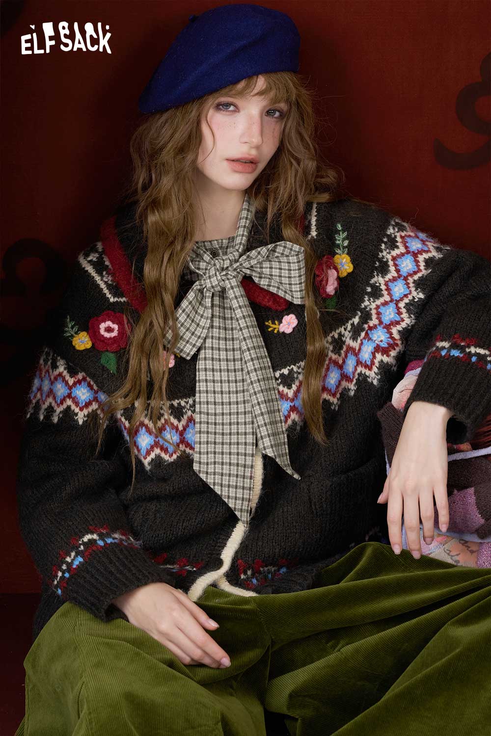 ELFSACK preppy bow tie blouse for women styled with a colorful patterned cardigan and green trousers