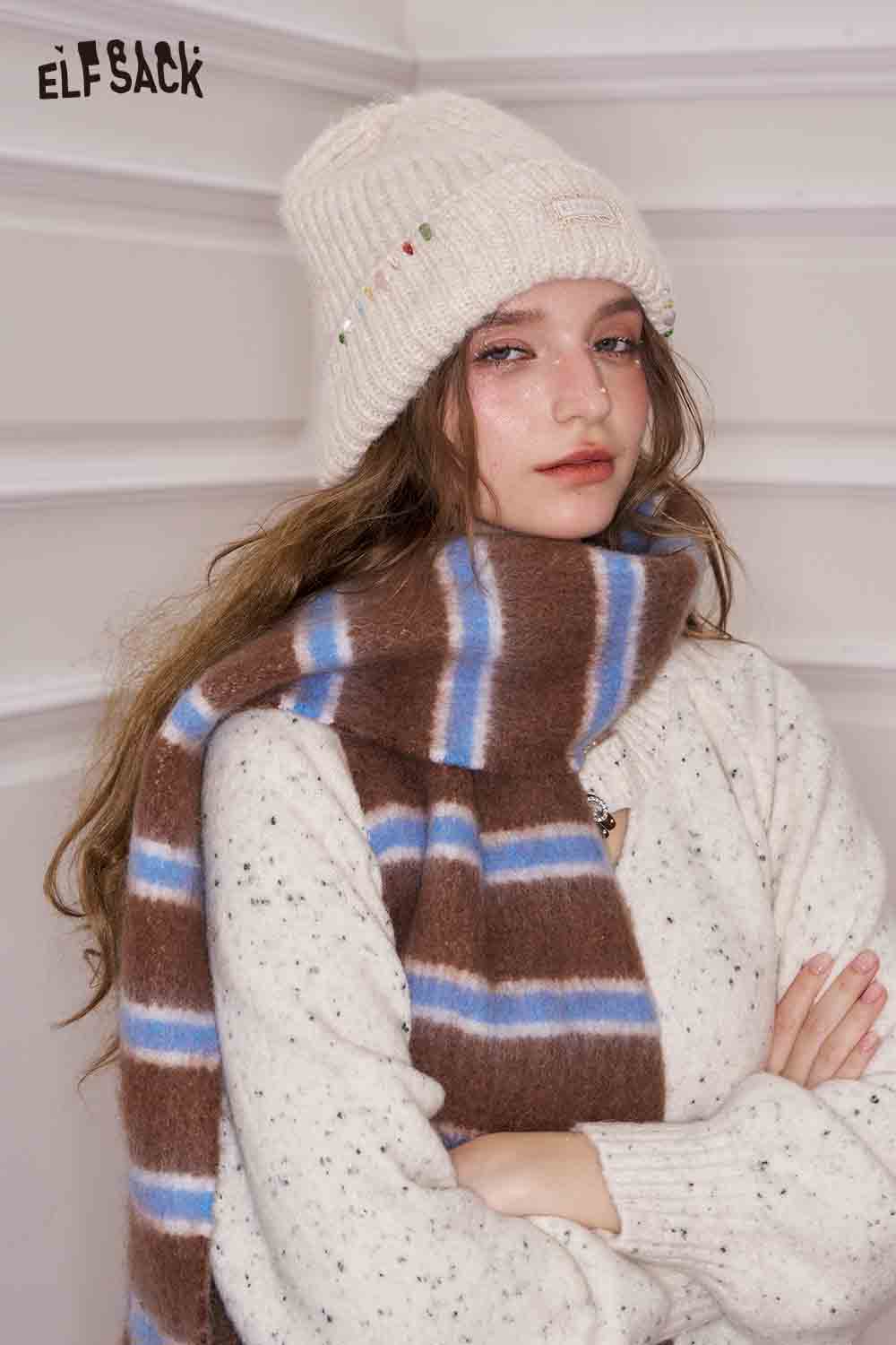 ELFSACK preppy striped fringe scarf in brown and blue, styled with a cozy sweater and beanie