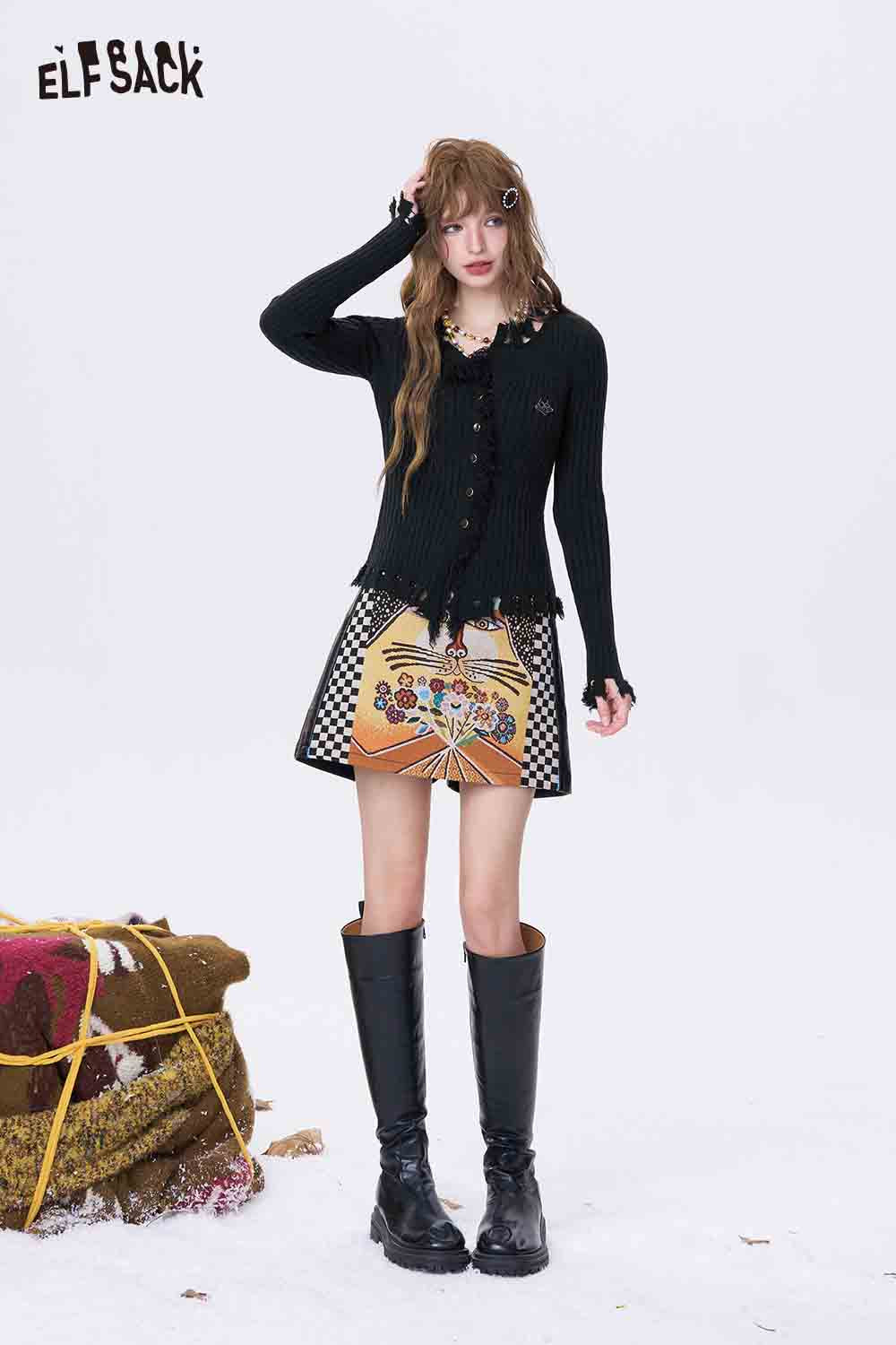 ELFSACK slim fit heart logo knit sweater styled with a patterned skirt and knee-high boots