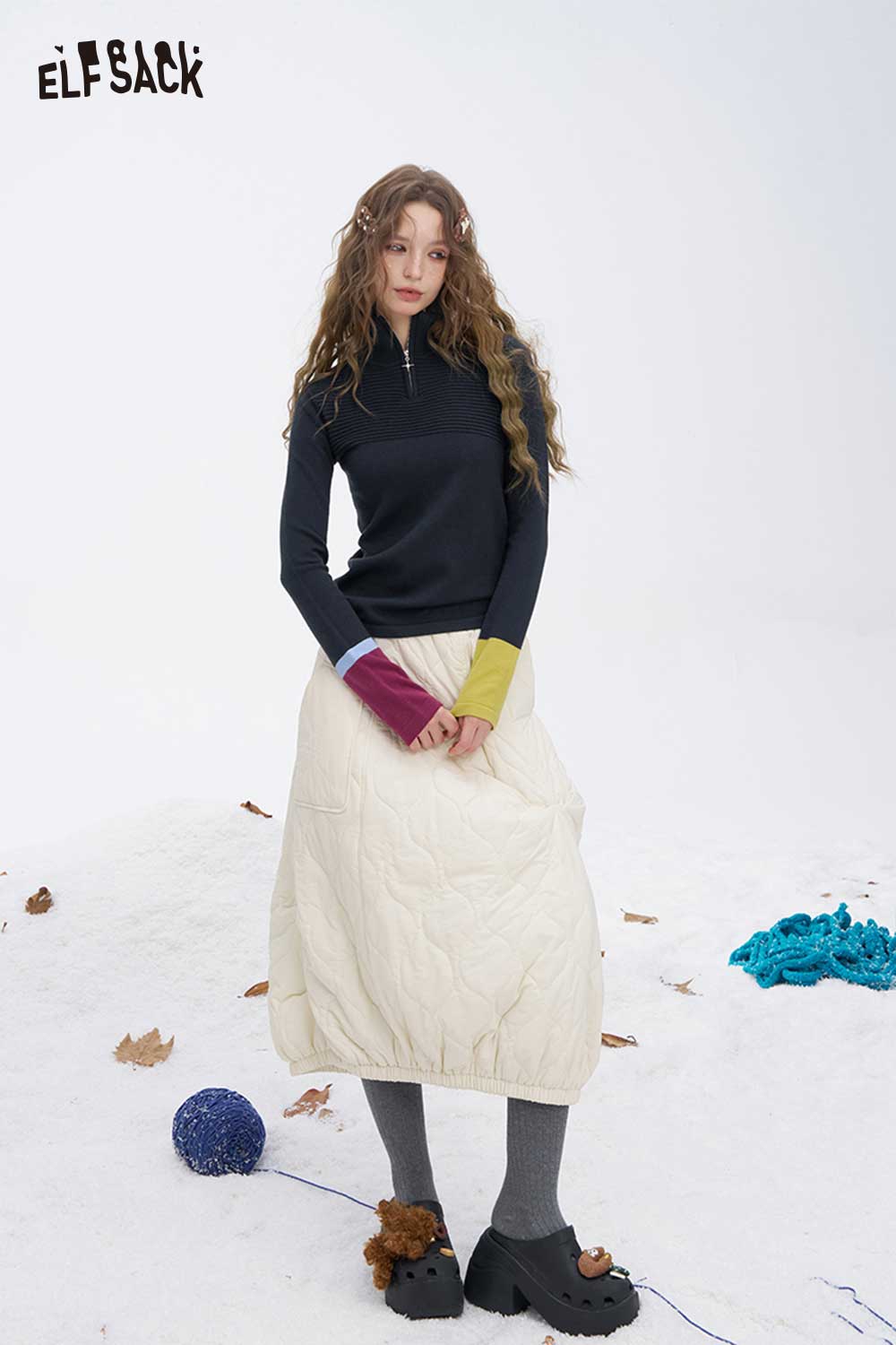 ELFSACK soft contrast sleeve knitwear featuring a stylish half-zip design and unique color-blocked sleeves