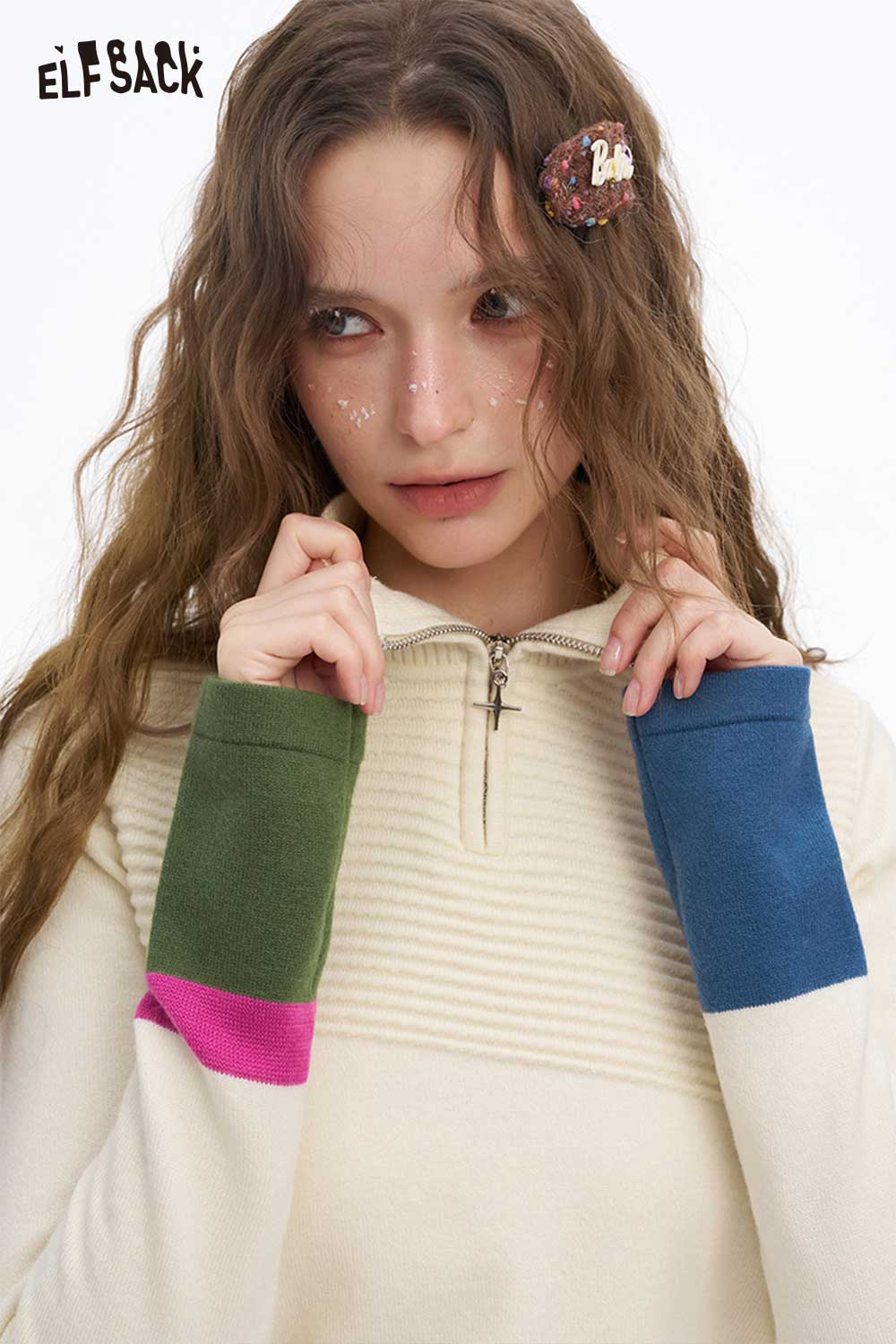 ELFSACK soft contrast sleeve knitwear featuring a zipper and colorful sleeves