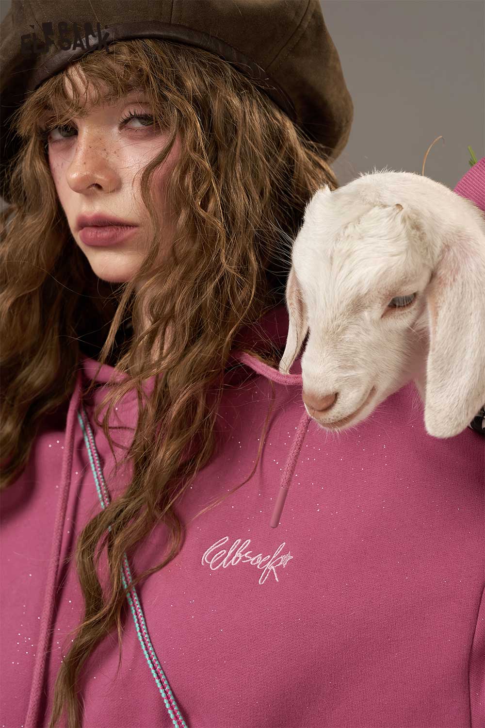 ELFSACK soft cropped hoodie for women in pink with a model holding a goat