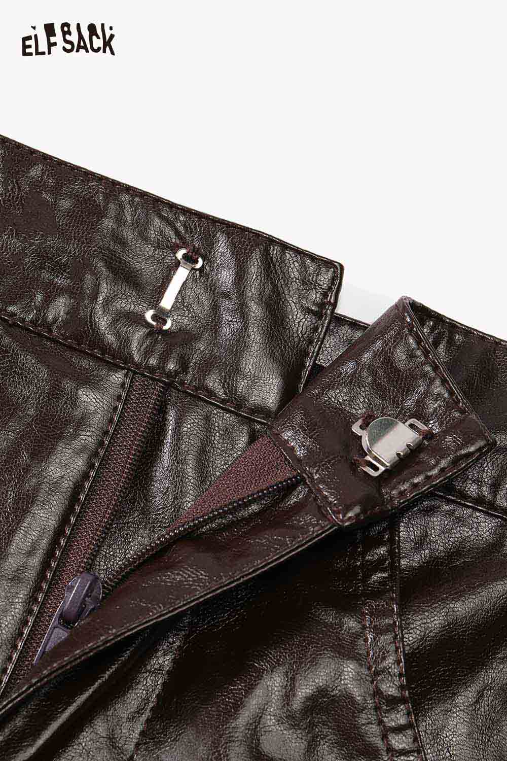 Close-up of ELFSACK soft shiny leather skirt with zip and button detailing for a chic look