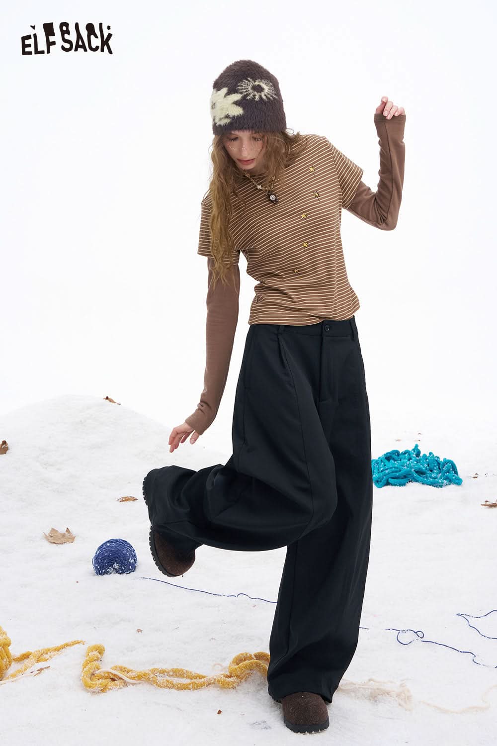 ELFSACK women's wide leg floor length pants paired with a striped shirt and cozy hat for a stylish winter look