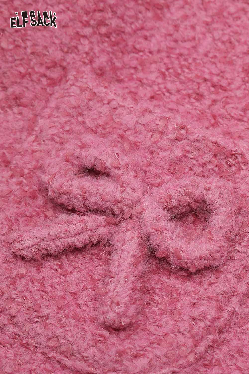 Close-up of ELFSACK wool blend bow detail coat featuring a soft pink texture and charming bow design