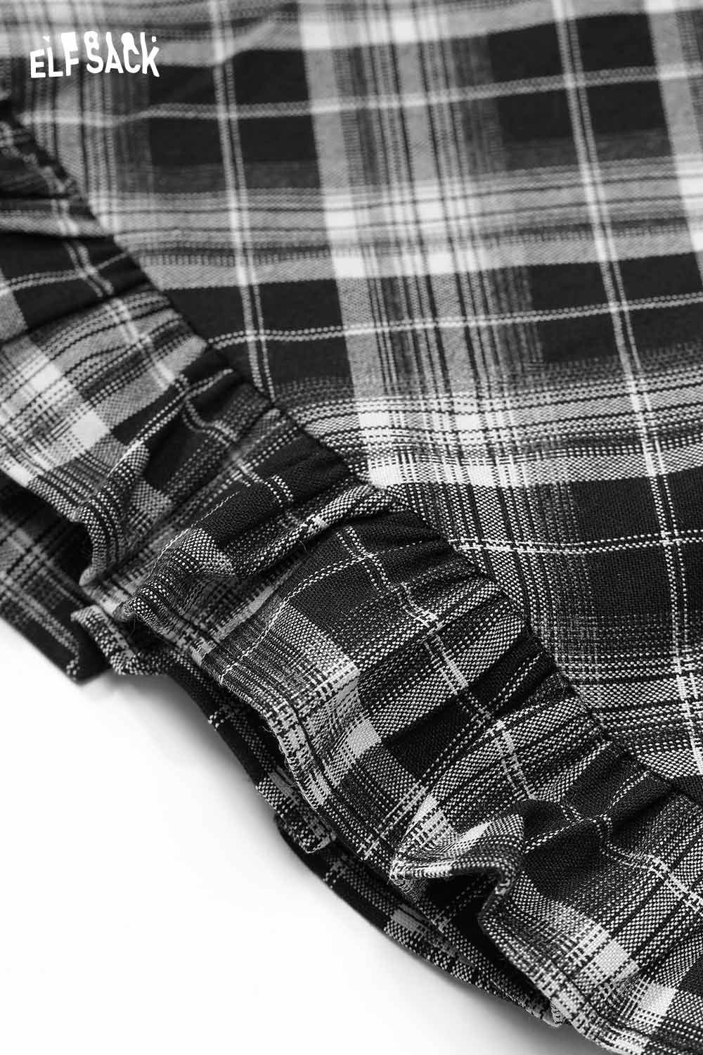 Close-up of ELFSACK wool blend checkered skirt with ruffled hem detail in black and grey plaid
