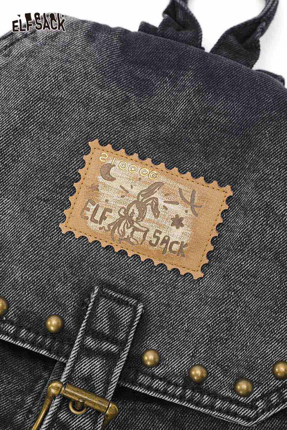 Vintage black denim backpack with leather patch and metal accents for stylish everyday use