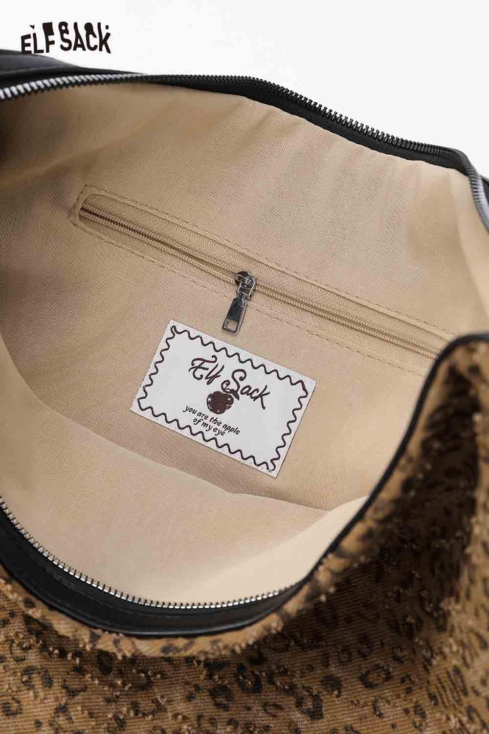 
                  
                    Interior view of ELFSACK vintage leopard shoulder bag showcasing the spacious compartment and zipper pocket
                  
                