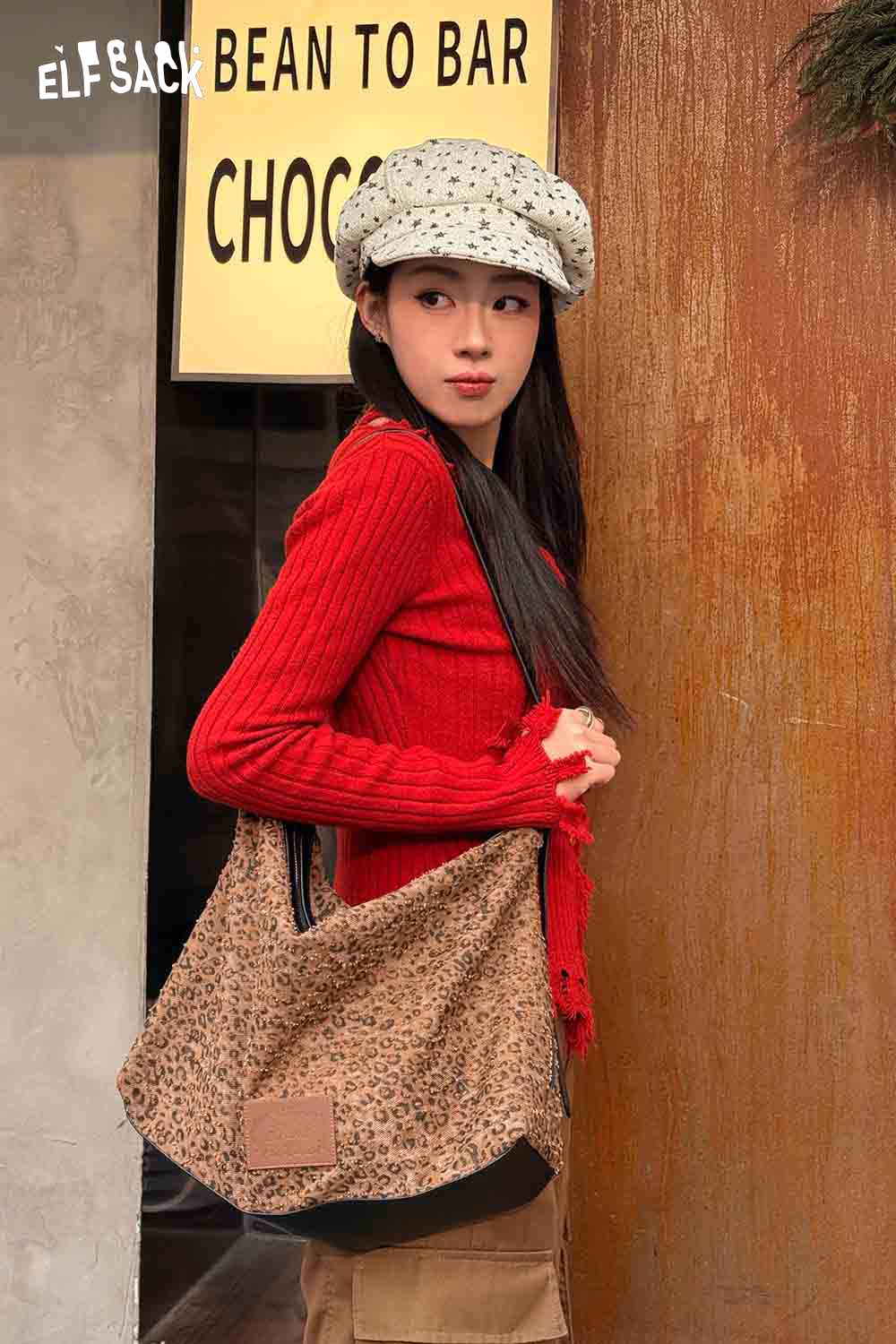 Stylish ELFSACK vintage leopard shoulder bag paired with a red sweater and polka-dot hat