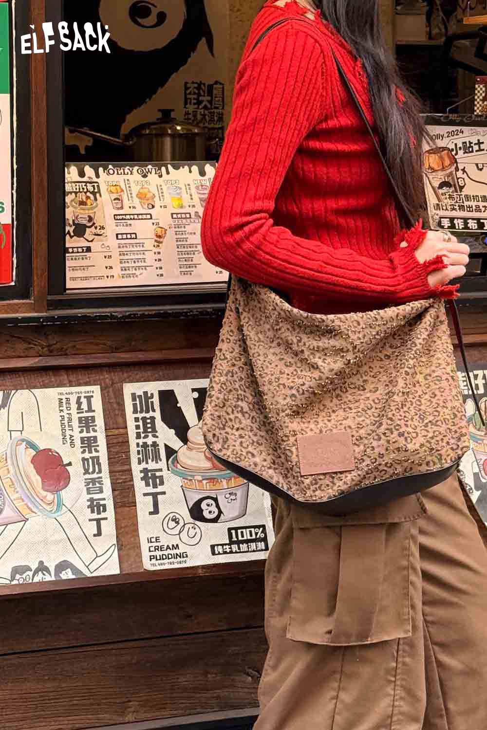 
                  
                    ELFSACK vintage leopard shoulder bag displayed on a woman in a red sweater
                  
                