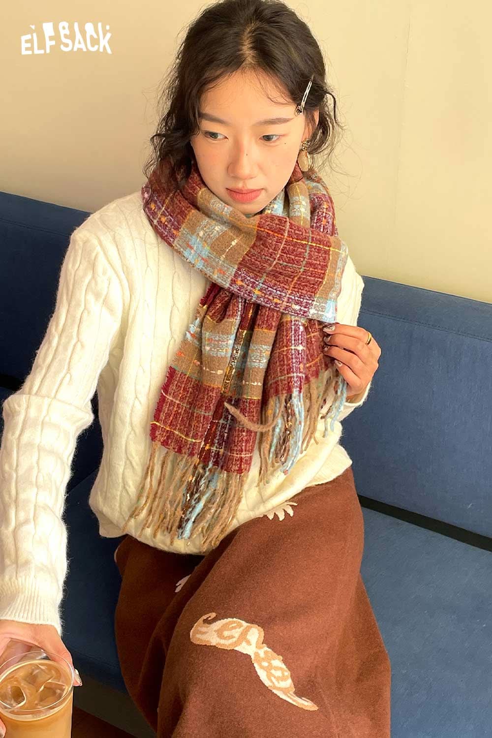 
                  
                    ELFSACK vintage plaid wool scarf wrapped around a model wearing a cozy sweater, styled for the season
                  
                