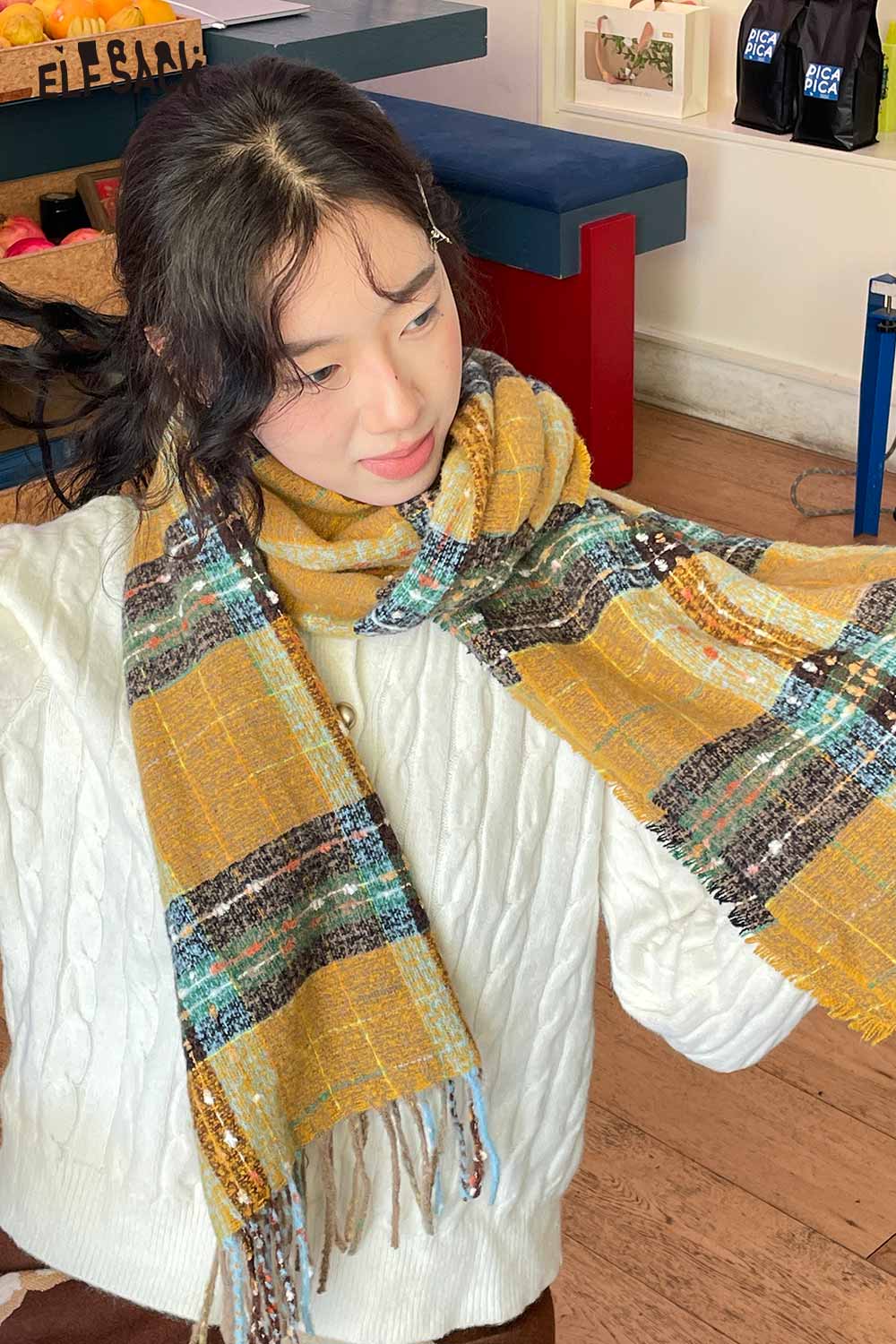 Model wearing a vintage plaid wool scarf in yellow and blue shades for stylish winter warmth