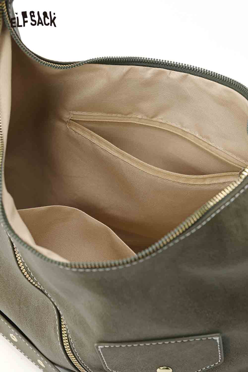 Interior view of vintage suede shoulder bag featuring spacious compartments and soft lining