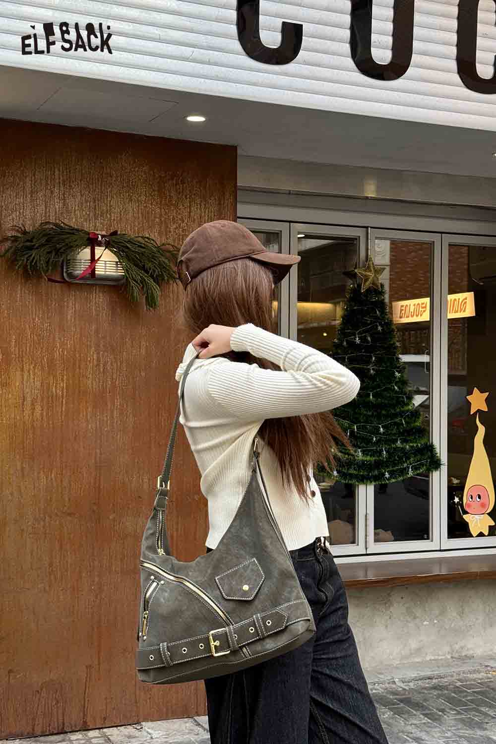 
                  
                    Stylish woman wearing a vintage suede shoulder bag with casual outfit in urban setting
                  
                