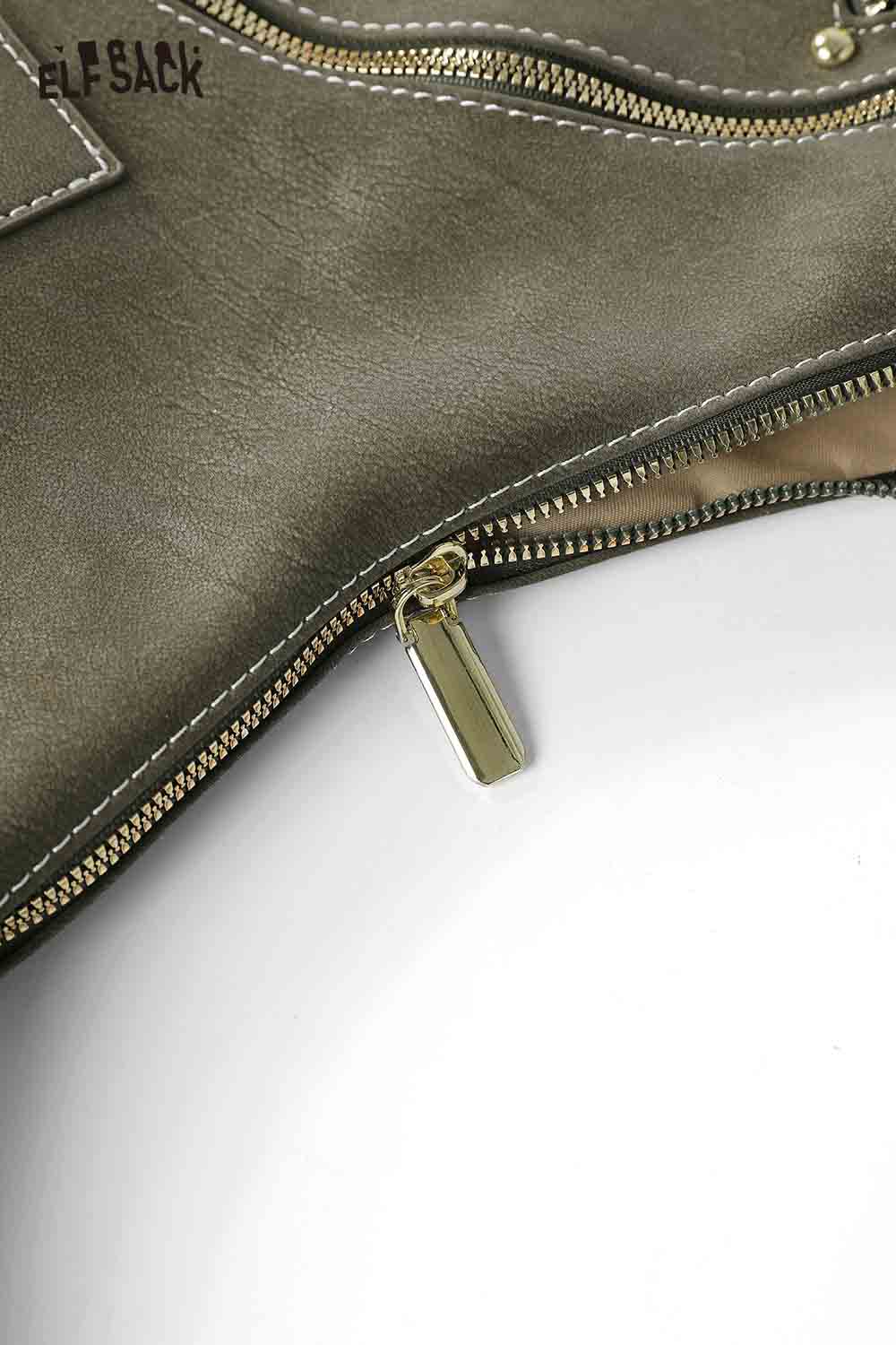 Detailed view of a vintage suede shoulder bag featuring a sleek zipper and quality stitching