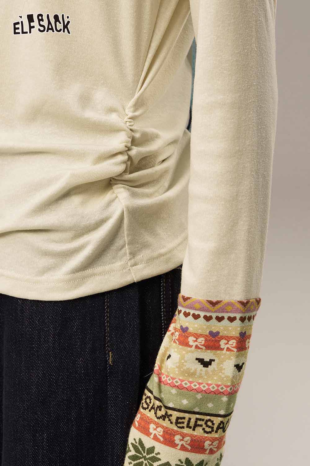 ELFSACK waist cinching long sleeve shirt featuring unique patterned sleeves and gathered side detail