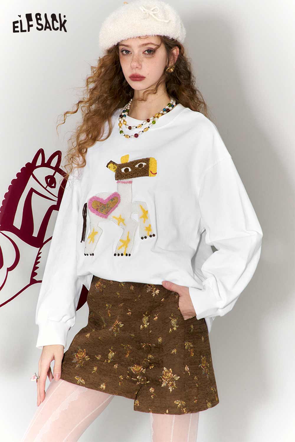ELFSACK whimsical pony sweatshirt featuring a playful cow design on a cozy white fabric