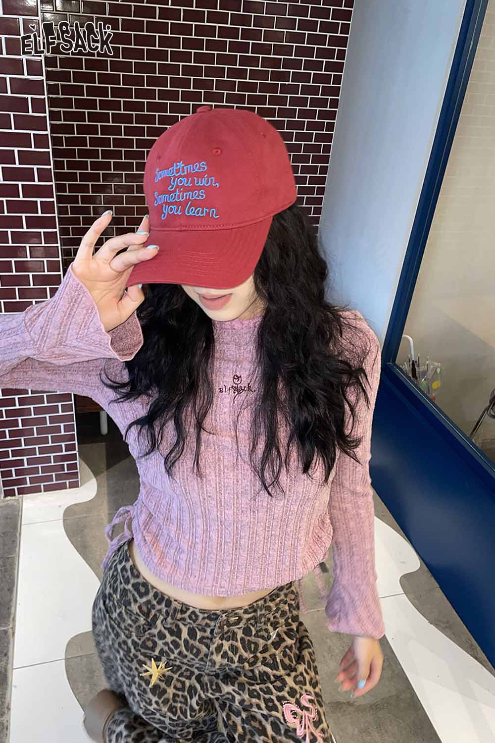 Trendy women's embroidered baseball cap in red featuring stylish lettering and a casual outfit